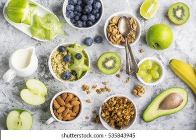 Ingredients for a healthy breakfast, nuts, oatmeal, berries, fruits, blueberry, almonds, walnuts The concept of natural organic food in season Top view