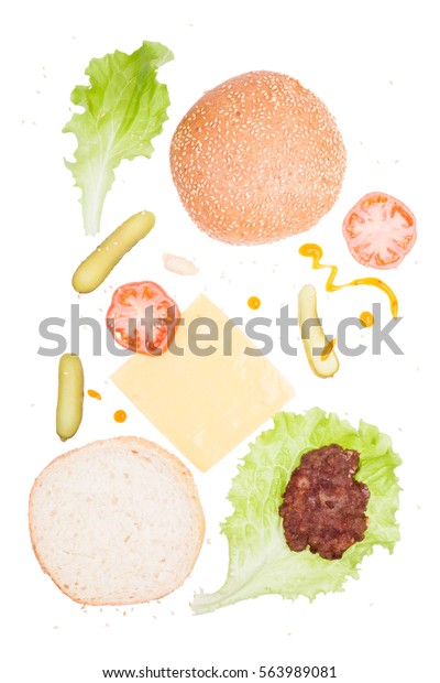 Ingredients for homemade fresh hamburger. On\
white background isolated. The view from the top. Vertical photos.\
Prepared for cooking. The food in the\
mess.