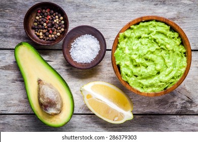 ingredients for homemade guacamole: avocado, lemon, salt and pepper top view - Powered by Shutterstock