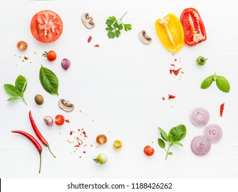 The ingredients for homemade pizza on white wooden background. - Shutterstock ID 1188426262