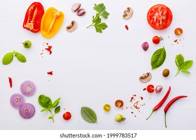 The ingredients for homemade pizza on white wooden background. - Shutterstock ID 1999783517