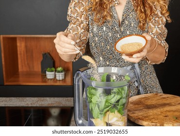 Ingredients including mint, lemon, and sugar being added to a blender for a fresh and healthy drink. - Powered by Shutterstock