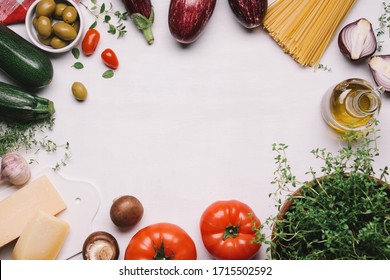 Ingredients Of Italian Food. Spaghetti, Tomatoes, Olives, Olive Oil, Parmesan, Traditional Mediterranean Vegetables And Herbs. White Food Background