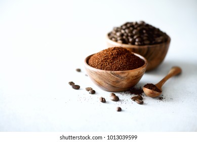 Ingredients for making caffeine drink - coffee beans, ground and instant coffee on light concrete background, copy space. Banner.