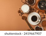 Ingredients for making coffee. Moka pot, Turkish coffee pots (cezve), coffee grinder with coffee beans, milk, sugar and spices on a brown background. Drink preparation concept. Flat Lay.Copy space.