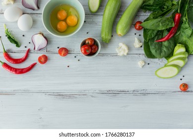 Ingredients For Making Healthy Vegan Food. Cauliflower, Zucchini, Onion, Green Beans, Eggs, Tomatoes, Chili Pepper And Spinach Leaves For Making Veggie Frittata. Clean Eating, Vegetarian Food Concept