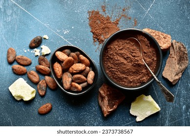 Ingredients for making homemade chocolate on a blue slate, stone or concrete table . Top view with copy space. - Powered by Shutterstock