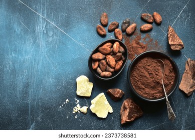 Ingredients for making homemade chocolate on a blue slate, stone or concrete table . Top view with copy space. - Powered by Shutterstock