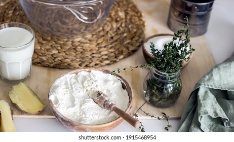 Ingredients For Making Homemade Herb Bread. On The Kitchen Table, A Glass Of Milk, Flour, Cheese, Butter, Thyme. Authentic Home Cooking Hobby, Home Baker