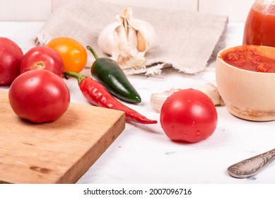 Ingredients For Making Homemade Mexican Hot Tomato Sauce On The Table - Chili Peppers, Jalapenos, Tomatoes, Garlic, Chopped Tomatoes