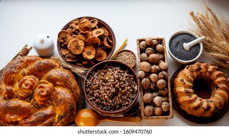 Ingredients For Making Kutia - Wheat Porridge For Orthodox Christmas. Nuts, Raisins, Poppy Seeds, Honey. Christmas Cake On The Table. Pie With Poppy Seeds. Baking On An Isolated White Background.