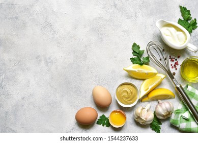 Ingredients For Making Mayonnaise Salad Dressing On A Light Slate, Stone Or Concrete Background. Top View With Copy Space.