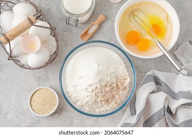 Ingredients for making sweet bread, brioche or challah bread. Yeast, flour, eggs, milk on a gray concrete background. Top view - Powered by Shutterstock