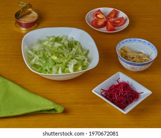 Ingredients For Making Tuna And Green Vegan Salad Decorated With A Napkin On A Wooden Background.