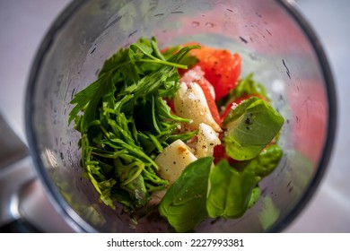Ingredients for pesto sauce prepared with chopper or mixer machine. Selective Focus center