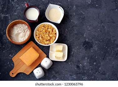 Ingredients For The Preparation Of Mac And Cheese: Dry Pasta, Orange Cheddar Cheese, Wheat Flour, Bread Crumbs, Milk, Butter, Salt, Pepper