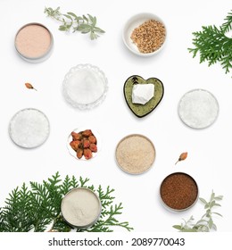 Ingredients For The Production Of Cosmetics On A White Background. Clays, Wax, Herbal Powders, Dried Flowers, Raspberry Ketone, Menthol Crystals. Natural Cosmetics Background.