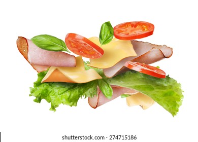 Ingredients for sandwich falling in the air isolated on white - slices of fresh tomatoes, ham, cheese and lettuce - Powered by Shutterstock