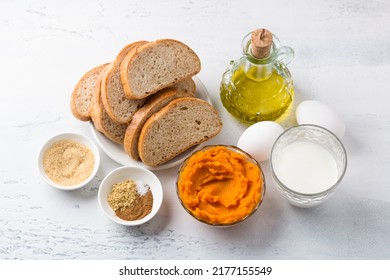 Ingredients For Spicy Pumpkin Toast: Pumpkin Puree, Bread, Eggs, Milk, Vegetable Oil, Brown Sugar And Spices - Ginger, Cinnamon, Salt. Cooking Delicious Homemade Food On A Light Gray Background