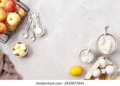 Ingredients for a sweet apple pie on a stone light background. Top view - Powered by Shutterstock