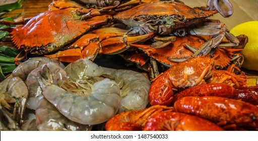 Ingredients For A Traditional Cajun Seafood Boil With Crab Shrimp Crawfish Corn Andouille Sausage Onions And Red Potatoes Lemon Onions Selective Focus 