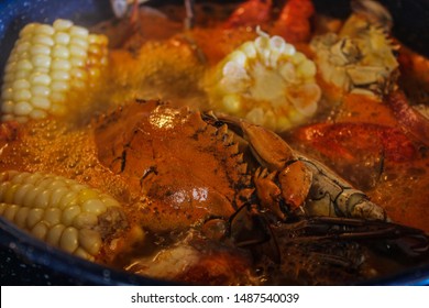 Ingredients For A Traditional Cajun Seafood Boil With Crab Shrimp Crawfish Corn Andouille Sausage Onions And Red Potatoes Lemon Onions Selective Focus 