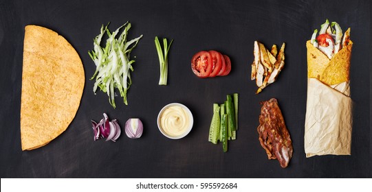 Ingredients For Wrapped Sandwich Over Dark Background. Top View