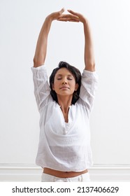 Inhale Confidence, Exhale Doubt. Shot Of A Beautiful Young Woman Stretching During A Yoga Session.