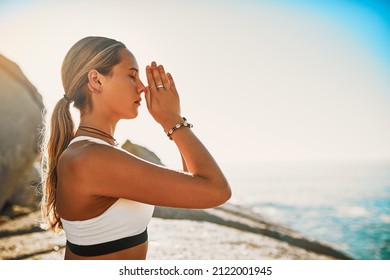 Inhale Courage, Exhale Fear. Shot Of An Athletic Young Woman Practicing Yoga On The Beach.