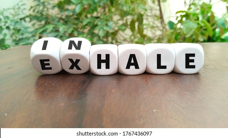 Inhale Exhale Concept Hand Turns Dice And Changes The Word INHALE To EXHALE