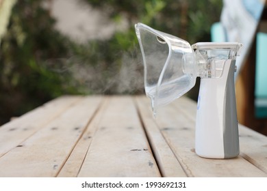 
Inhaler, White Portable Nebulizer On A Table