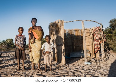Inhambane Mozambique, june 24, 2019 : A single Mother with her kids next to her house with no roof in Benguerra Island Vilankulos.