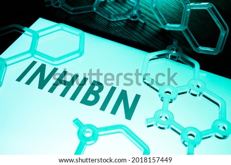 Inhibin hormone phrase with chemical models on the desk. Stock photo © 
