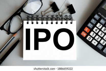 Initial Public Offering Concept. IPO. Text On White Notepad Paper On Gray Background. Business Concept. View From Above