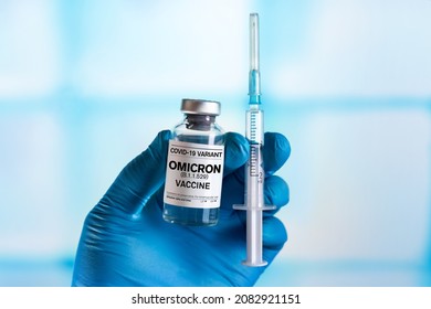 Injectable vaccine for the vaccination program of coronavirus Omicron. Doctor holds the hand Vaccine vial and syringe to administer vaccination doses for New Variant of the Covid-19 Omicron B.1.1.529 - Shutterstock ID 2082921151