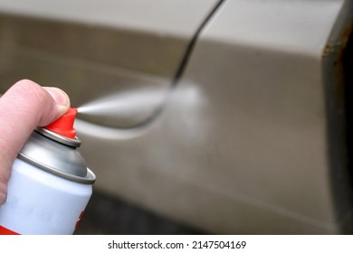 Injecting Anti-rust Spray To To Protect The Corroded Surface Of The Car. Rust Proof Oil Spray. Selective Focus.