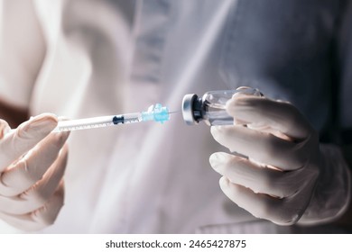 injecting injection vaccine vaccination medicine against covid-19 into a syringe. Close-up - Powered by Shutterstock