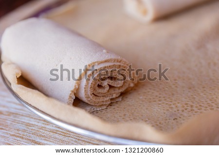 Injera, a fermented flatbread made with teff flour. It is a staple food of Ethiopia, Eritrea, Somalia and Djibouti