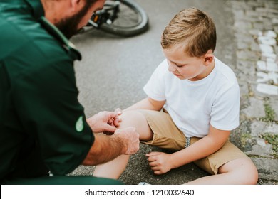 Injured boy getting help from paramedics - Powered by Shutterstock