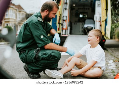 Injured boy getting help from paramedics - Powered by Shutterstock