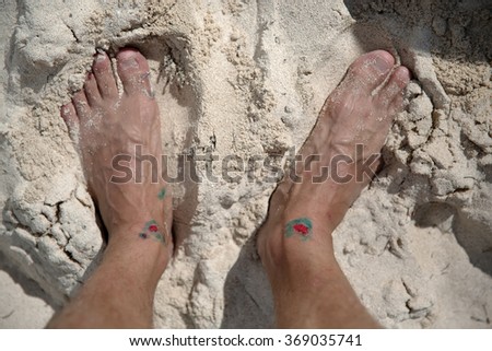 injured feet on the white sand