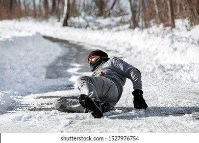 Injured man lying on the road, downfall and accident on winter season, black ice 