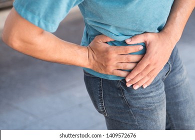 Injured Man Suffering From Pelvic Pain Or Hip Joint Injury