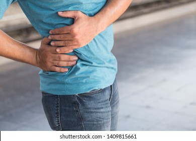 Injured Man Suffering From Pelvic Pain Or Hip Joint Injury