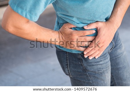 injured man suffering from pelvic pain or hip joint injury