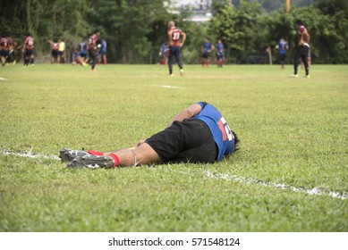 Injured Rugby player lying on the ground - Powered by Shutterstock