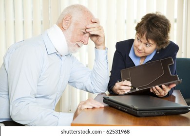 Injured Senior Man And His Accountant Worrying About The Cost Of Medical Bills.