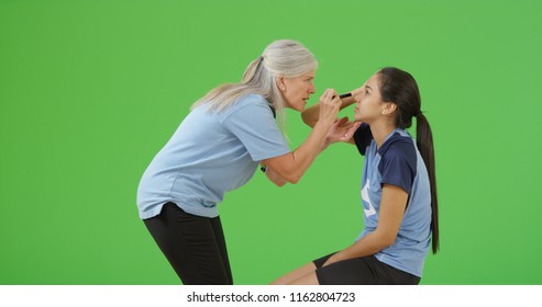 A Injured Soccer Player Is Checked For A Concussion On Green Screen