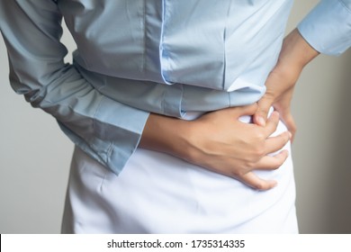injured woman suffering from pelvis pain or hip joint injury; concept of pelvic joint pain, hip joint dislocation, rheumatoid arthritis