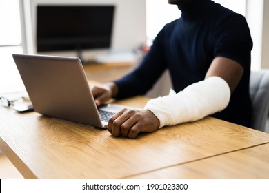 Injured Worker Compensation. Broken Arm African Man On Computer - Shutterstock ID 1901023300